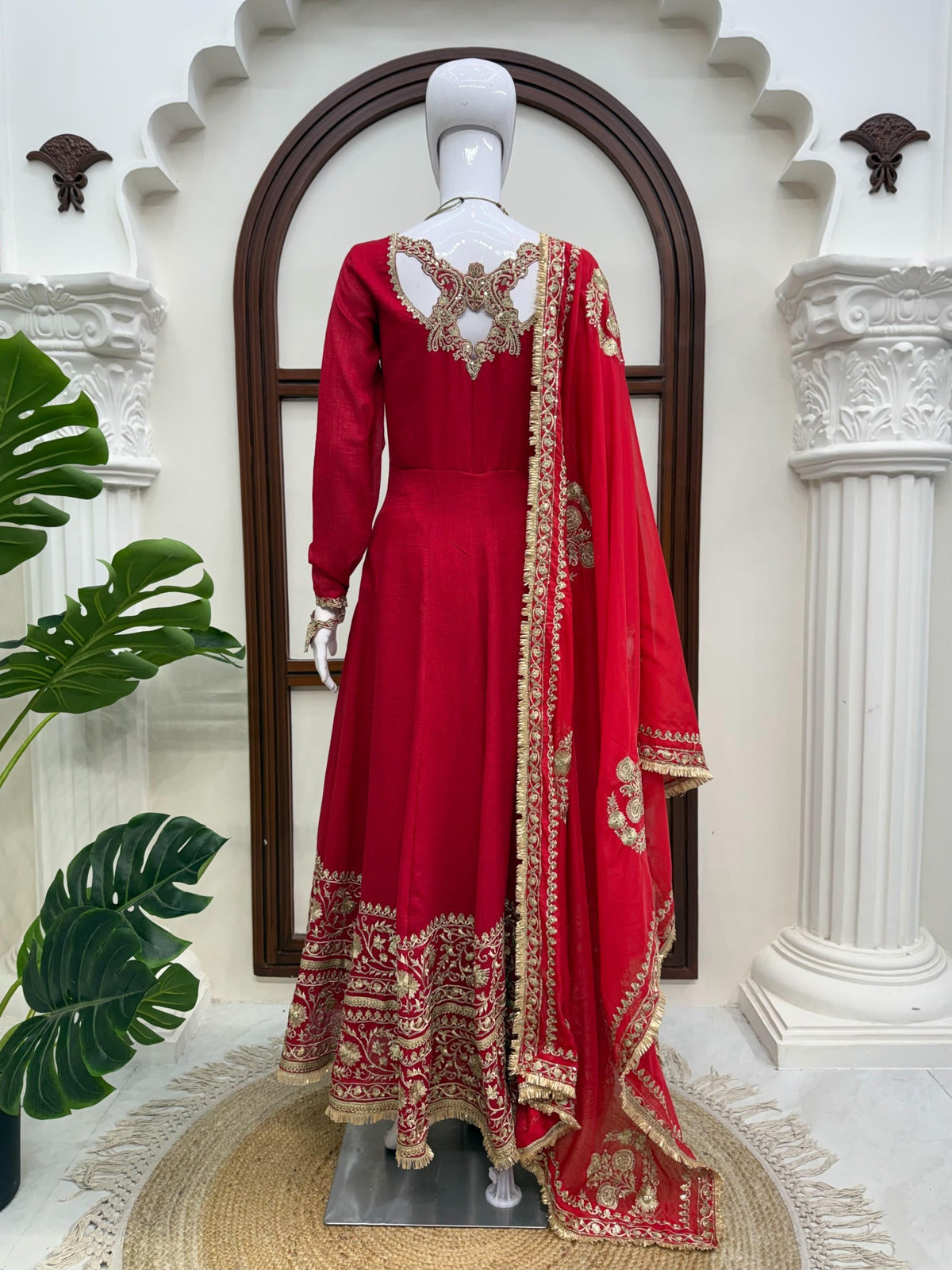 Red fully stitched designer gown set on mannequin