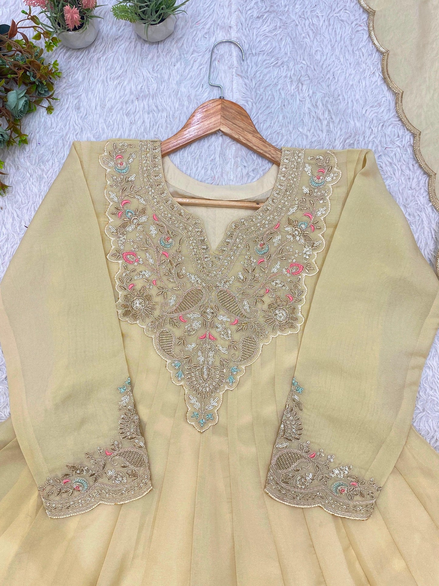 Close-up of beige cording and sequin embroidery neckline and sleeves