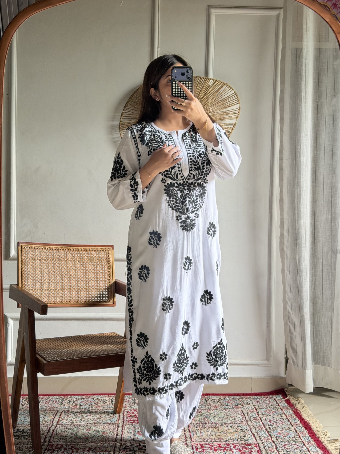Model wearing white base black thread Lucknow Chikankari rayon shalwar set