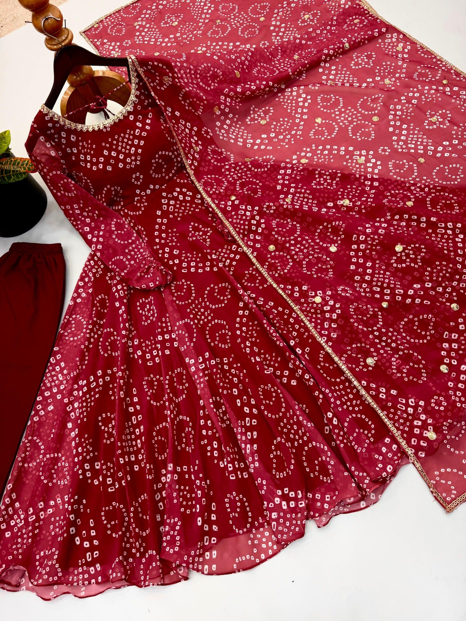 Red faux georgette gown and dupatta detailed flat lay