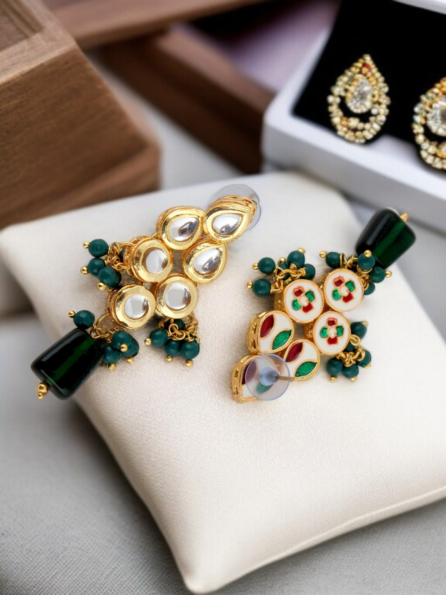 Detailed close up of matching green kundan earrings