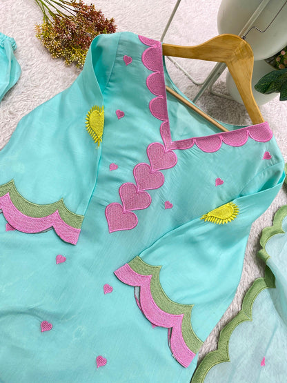 pink heart embroidery and scalloped border detail on aqua blue top