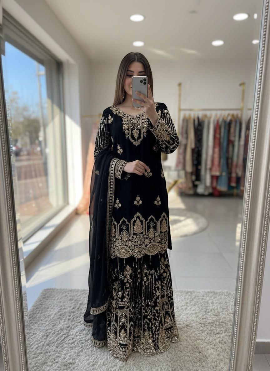 Black and gold embroidered georgette sharara suit with dupatta on model