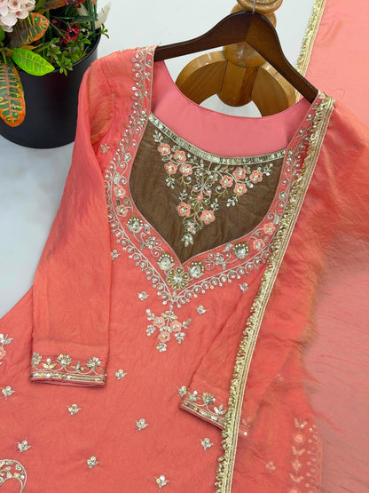 Coral peach top with mocha neckline and sequin embroidery close-up