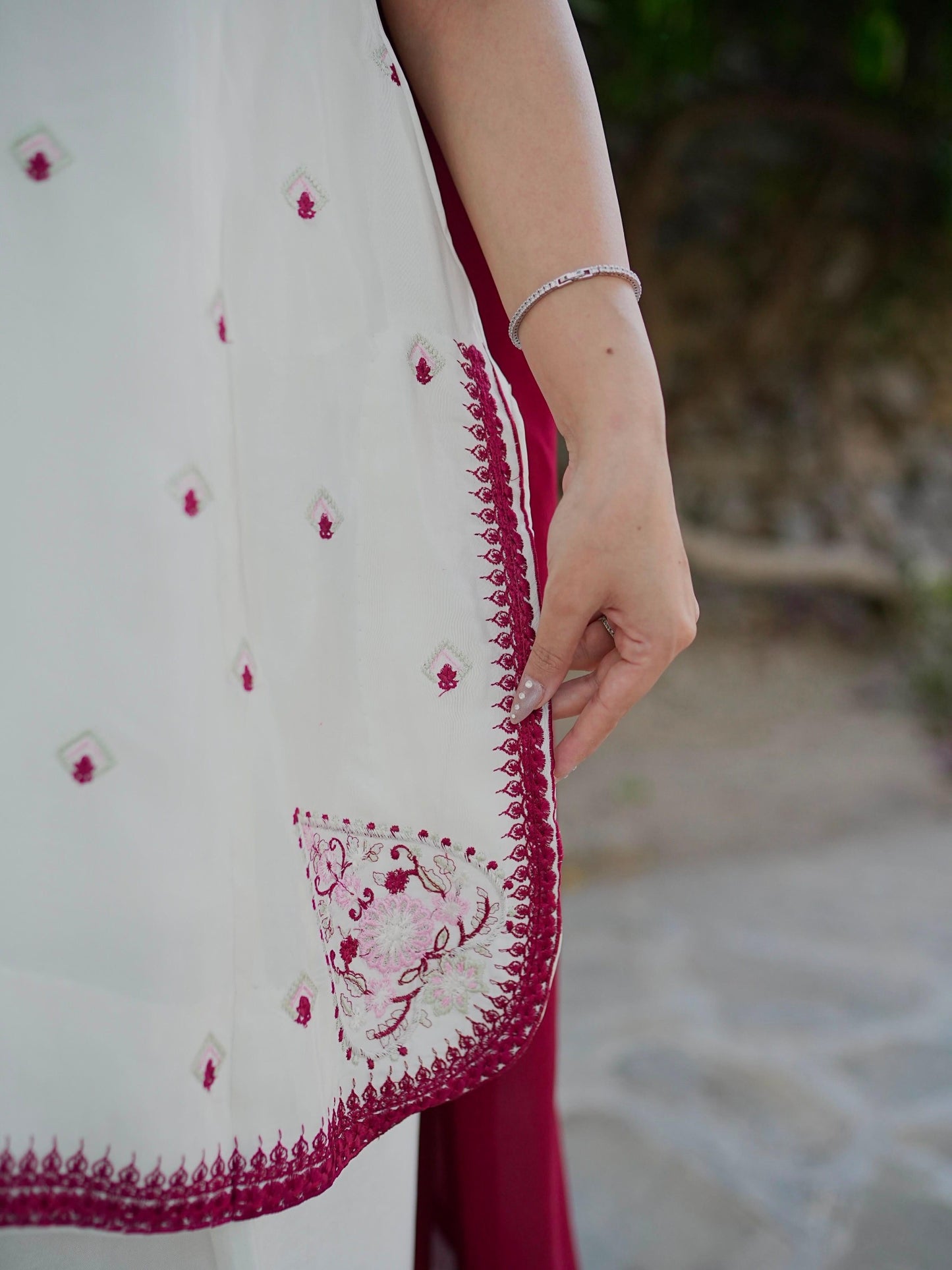 Ivory kurti wine embroidery and apple-cut hem detail
