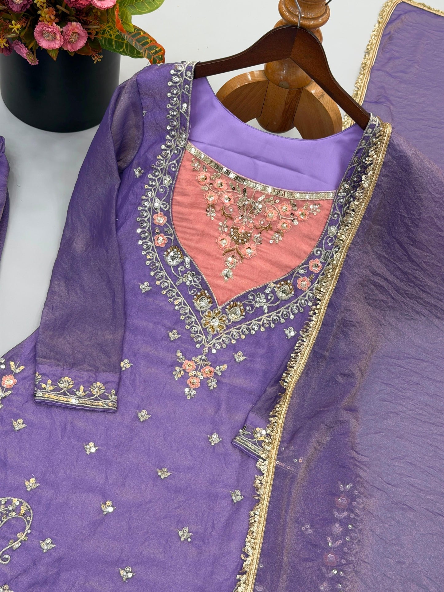 Lavender purple top with peach neckline and sequin embroidery close-up