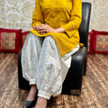 Mustard Yellow color Collar neck chikankari kurta teamed up with chikankari Afghani salwar