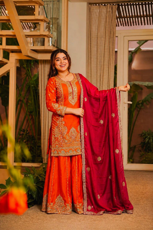 Model wearing orange Chinon silk embroidered kurti palazzo set with rani pink dupatta