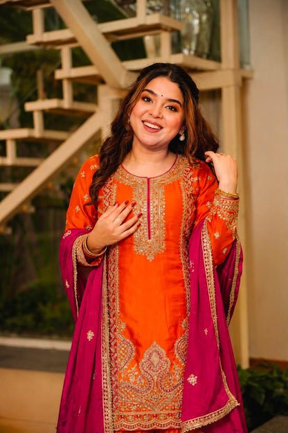Close-up of orange embroidered kurti with rich rani pink dupatta