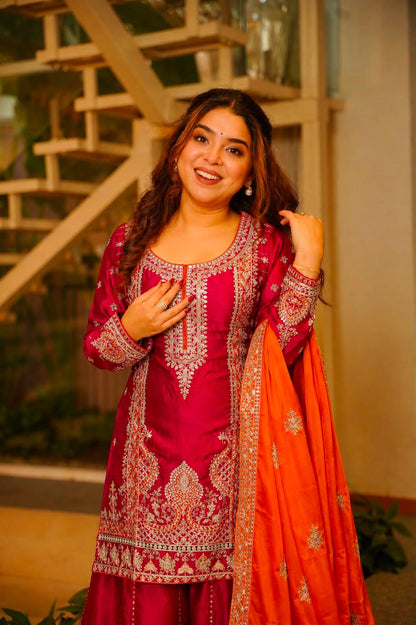 Model wearing Rani pink embroidered Chinon silk kurti with orange dupatta
