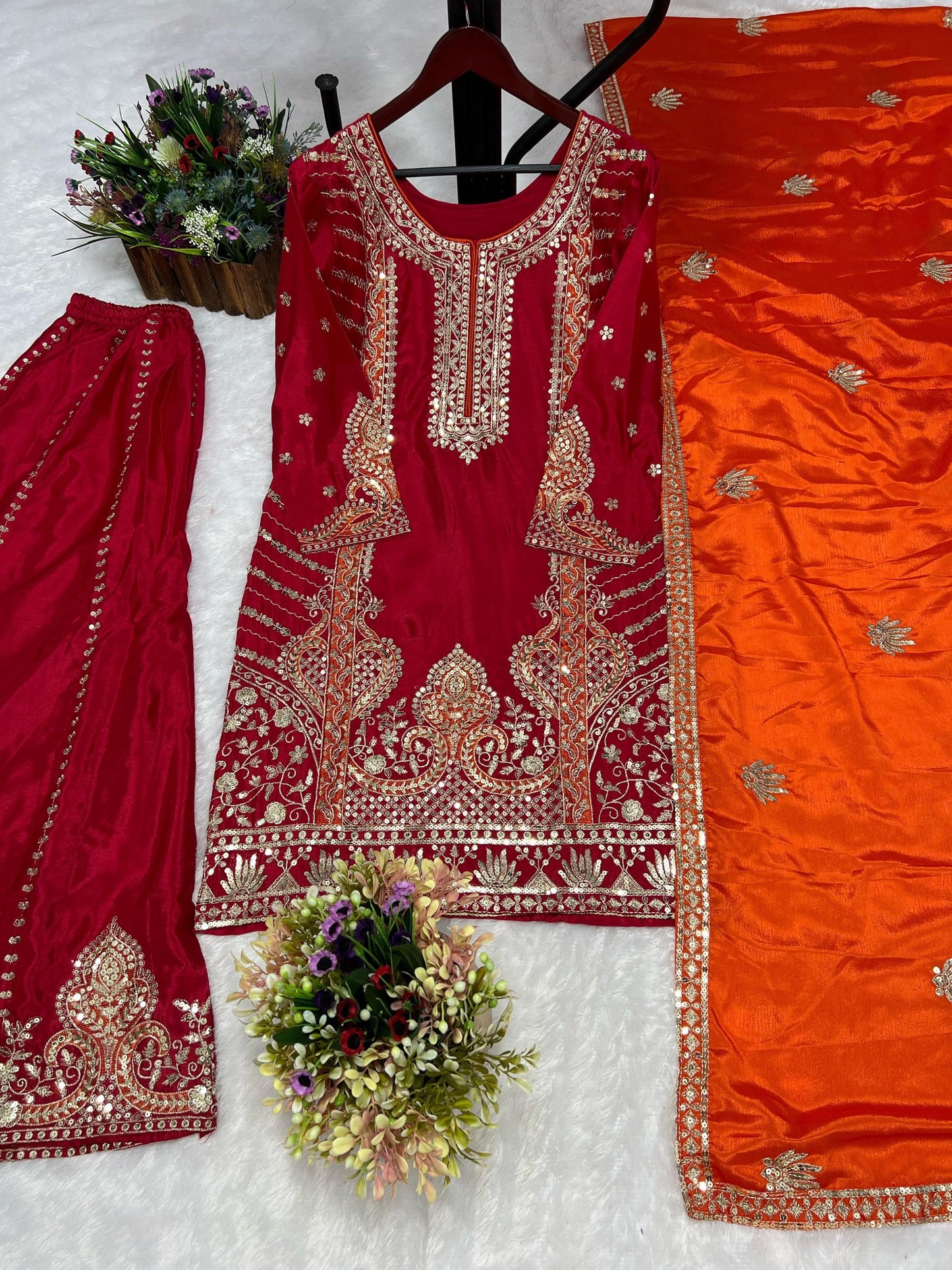 Front view of Rani pink embroidered kurti and palazzo with orange dupatta