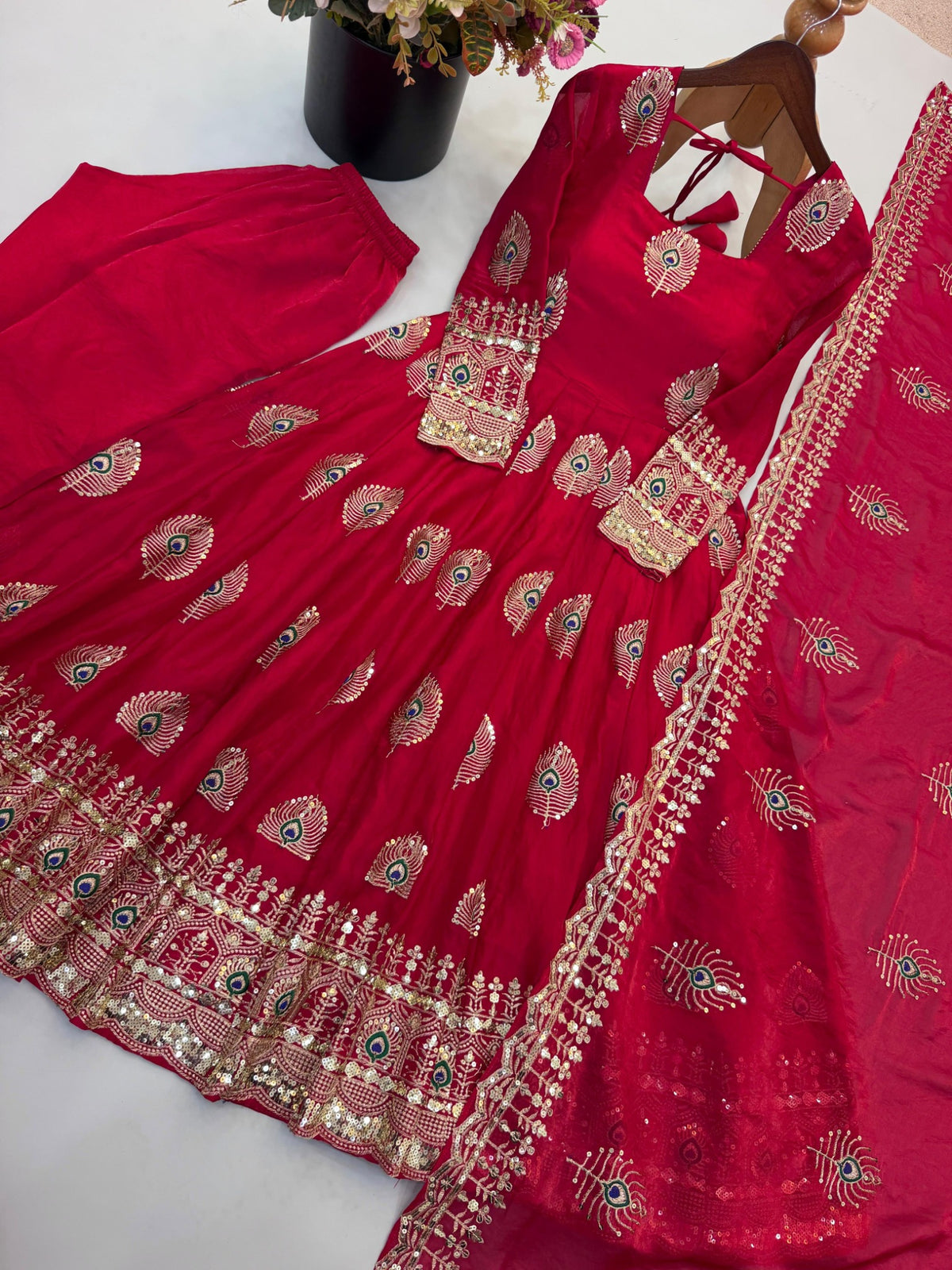 Rani pink Anarkali gown with peacock embroidery and ornate border