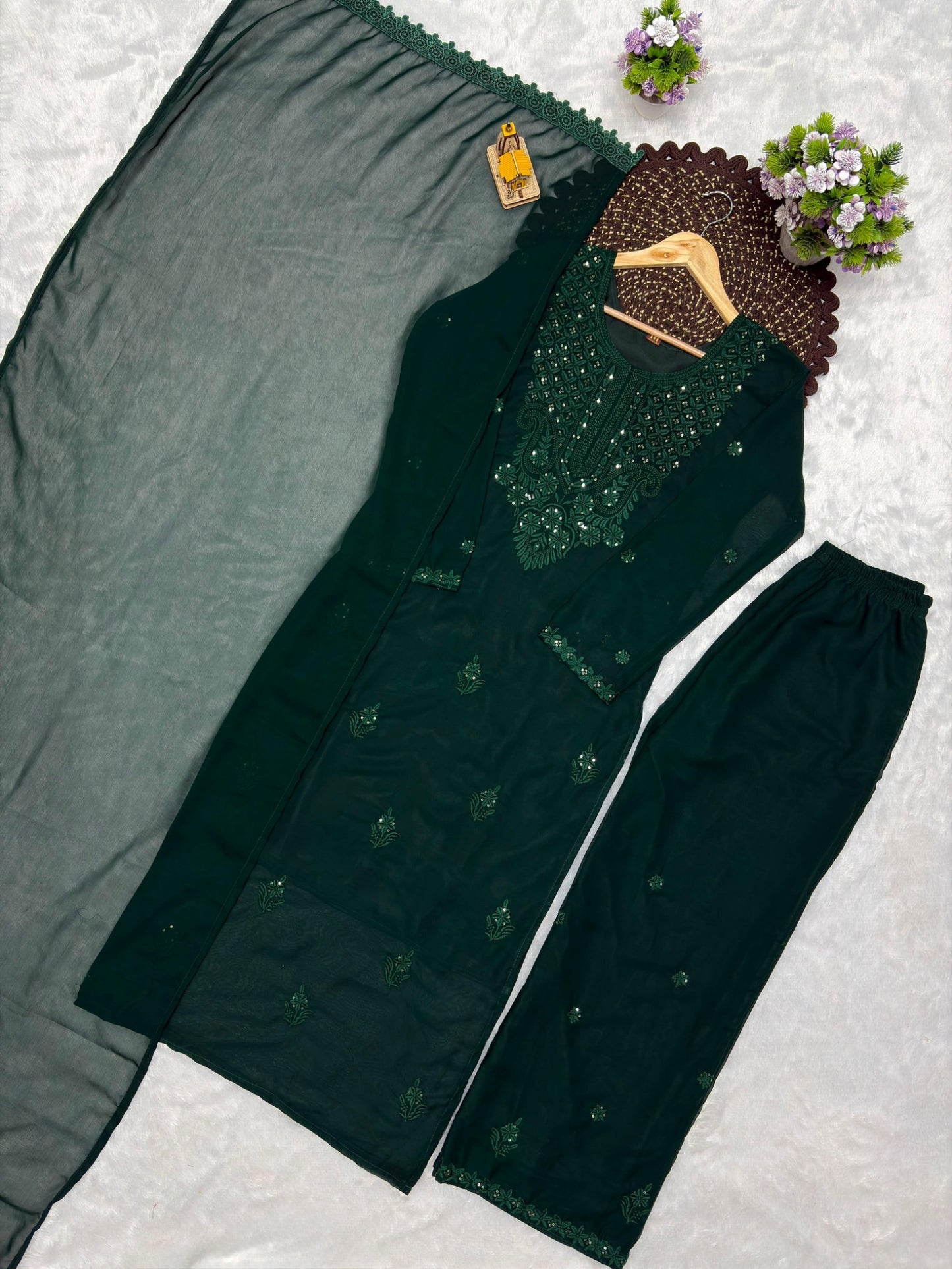 Dark green embroidered georgette kurta palazzo dupatta set flat lay