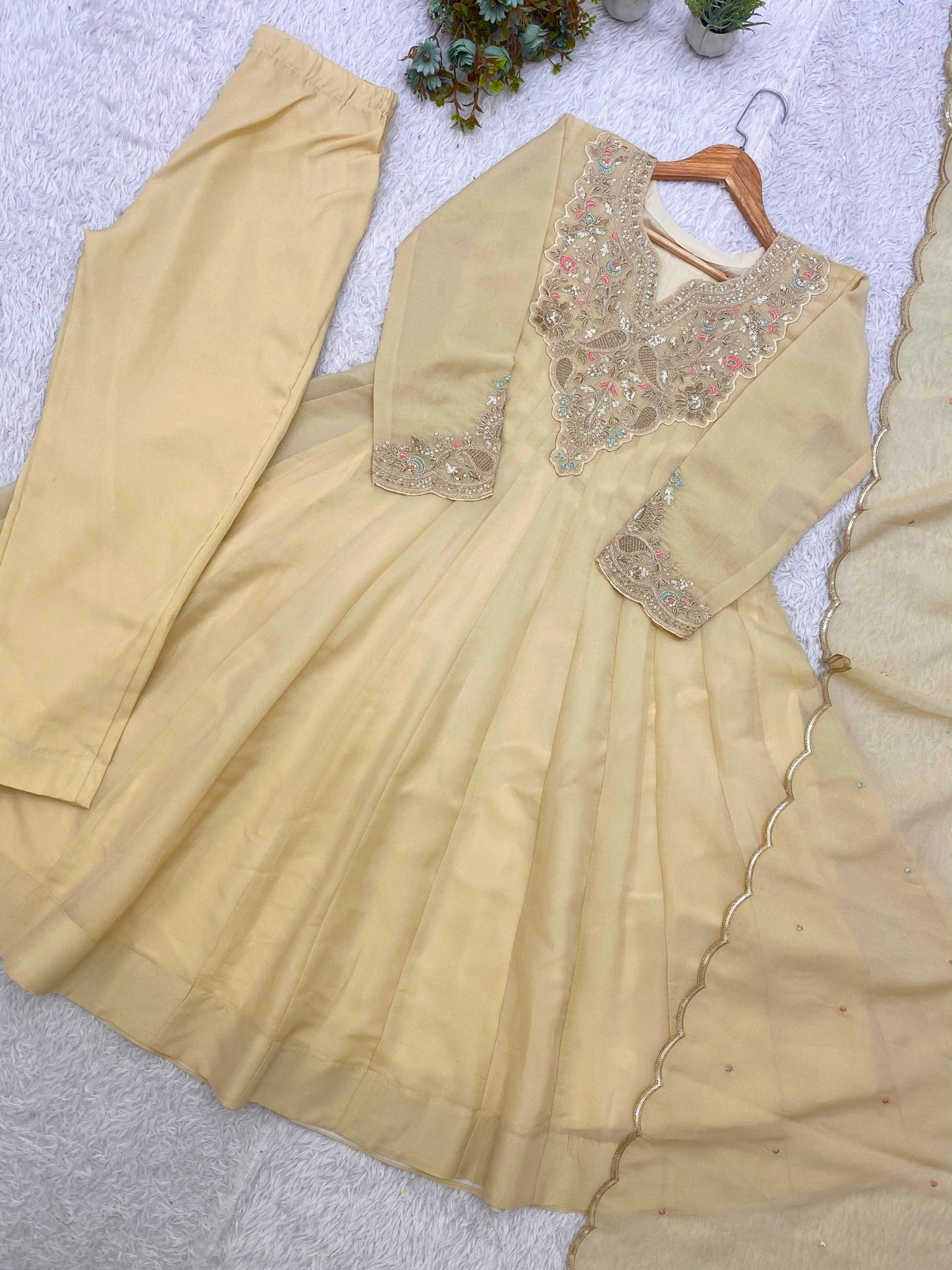 Beige designer gown with embroidered neckline and dupatta detail
