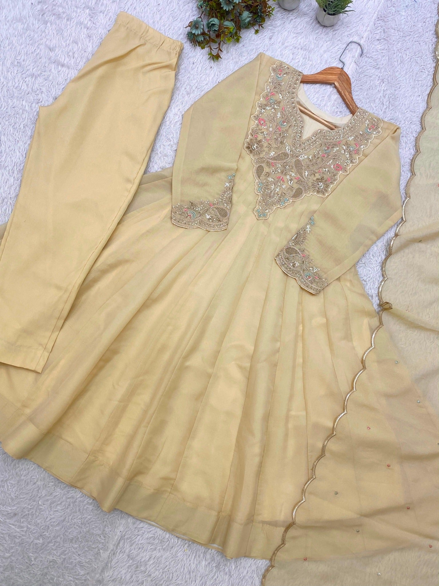 Beige designer gown with embroidered neckline and dupatta detail
