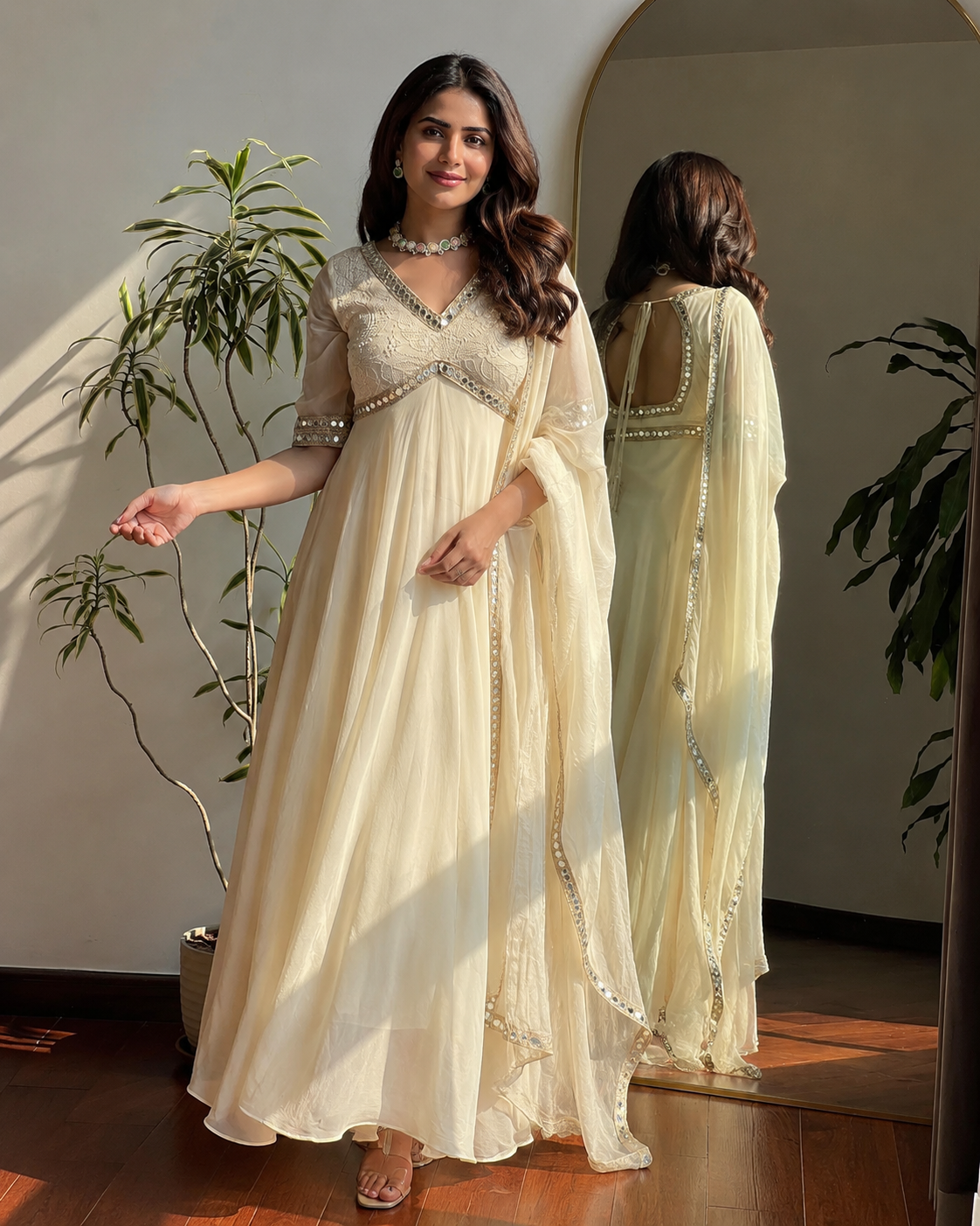 Off white faux georgette Anarkali gown with Chikankari and real mirror work lifestyle image