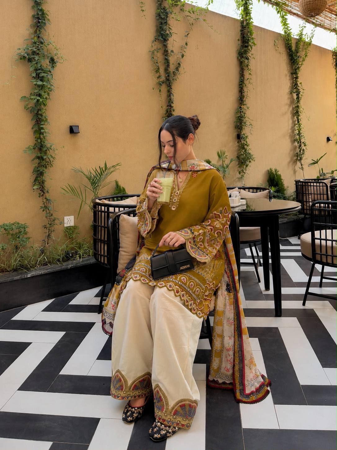 Mustard yellow Roman Silk kurti palazzo dupatta set seated lifestyle view