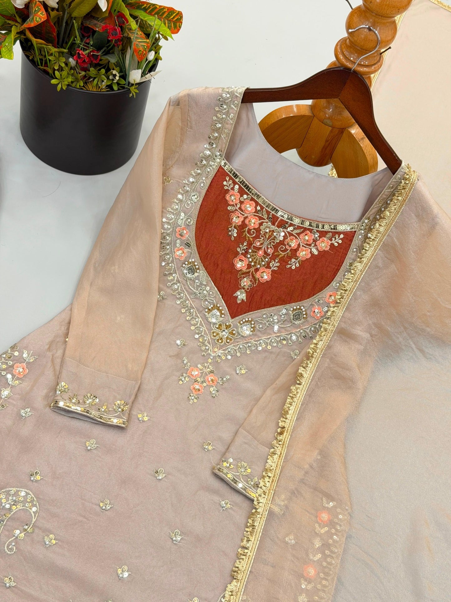 Taupe beige top with rust yoke and sequin embroidery close-up