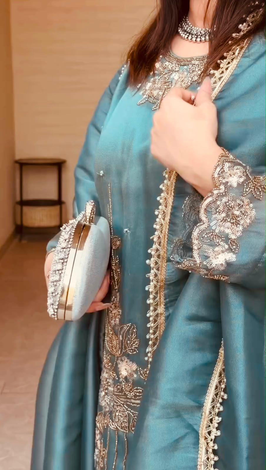 coding thread and sequin embroidery detail on teal blue suit