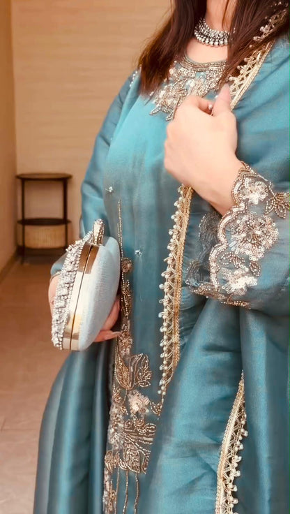 coding thread and sequin embroidery detail on teal blue suit