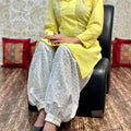 Yellow color Collar neck chikankari kurta teamed up with chikankari Afghani salwar
